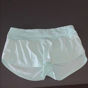 lulu speed up shorts 2.5” a light blue teal color